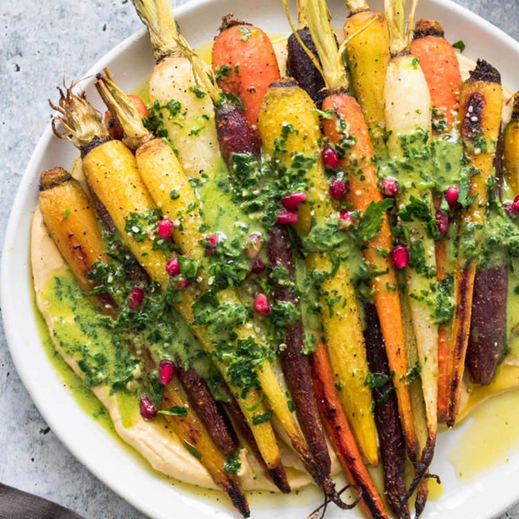 Roasted Whole Rainbow Carrots Over Creamy Hummus with Green Tahini Sauce